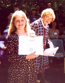 Cathy Schultz gives Sallie an award for her Esperanto progress